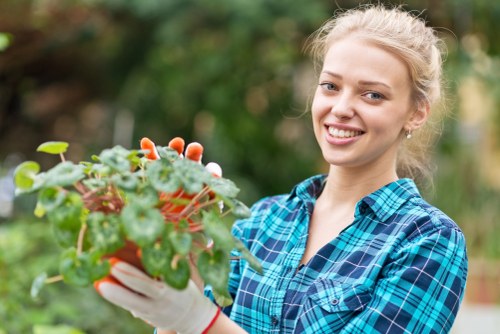 Staff member arranging garden pots for reuse