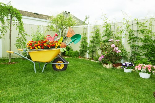 Gardener using tools near a flower bed with safety gloves